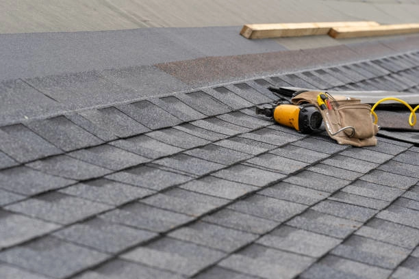 Roofing tools on gray shingles, showcasing installation progress and durability. -tile roof installation